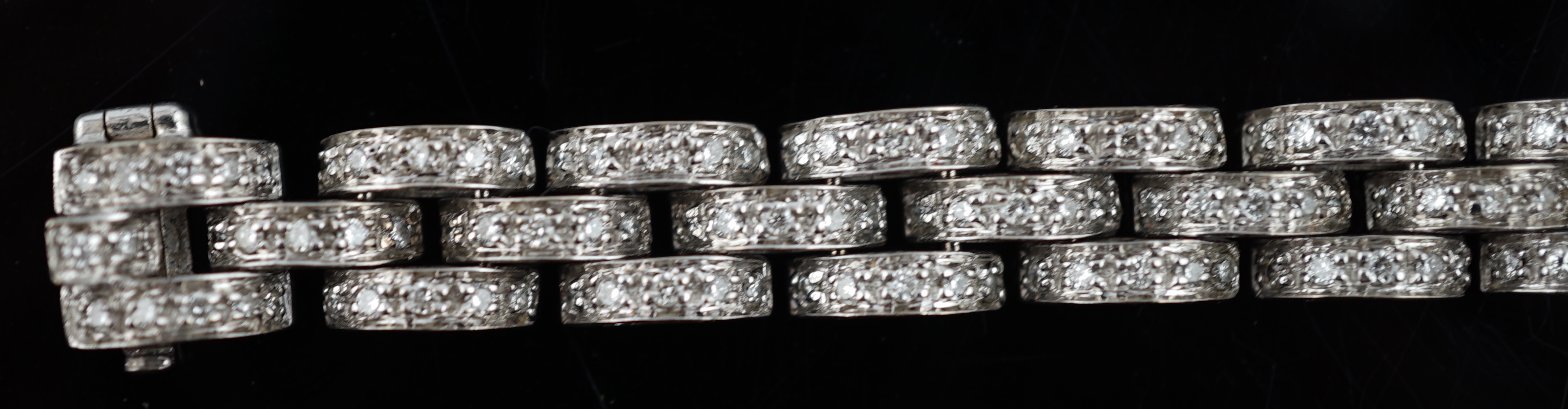 An 18k white gold and diamond chip set triple row bracelet